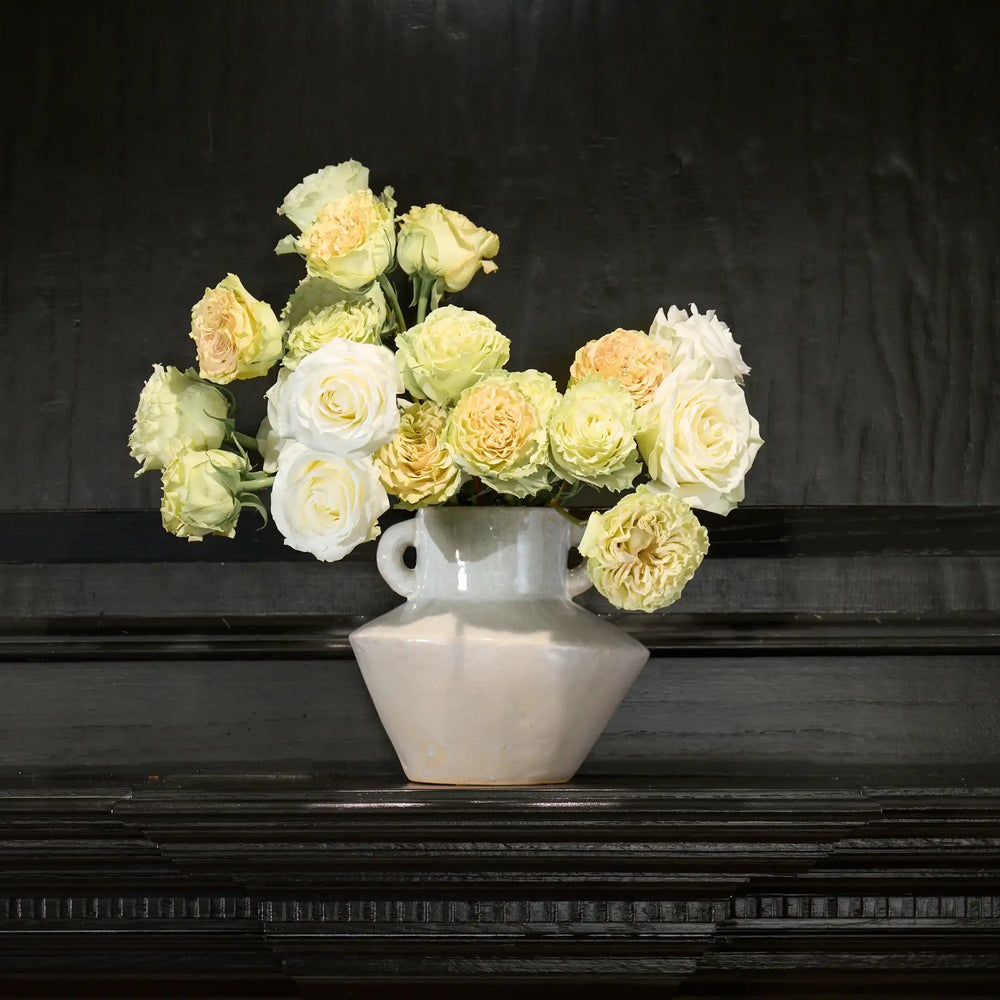 Vase with flowers on a dark surface